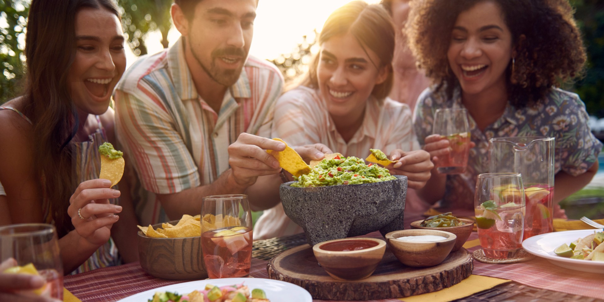 People enjoying guacamole and chips