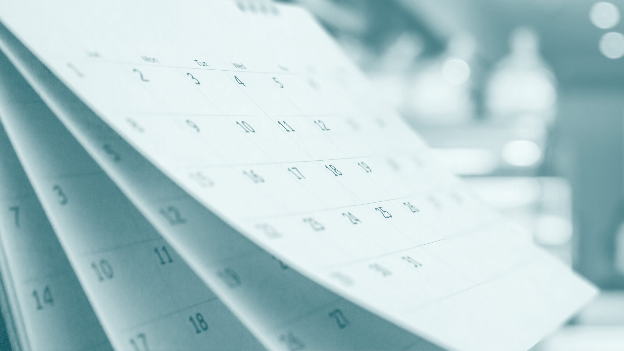 Six Things You Must Build Into Your Editorial Calendar D Custom - Close up white paper desk calendar with blurred bokeh background appointment and business meeting concept
